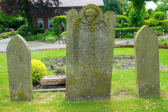 Niedersachsen, Wangerland,  Alte Grabsteine an der St. Severinus und Jacobus Kirche Minsen